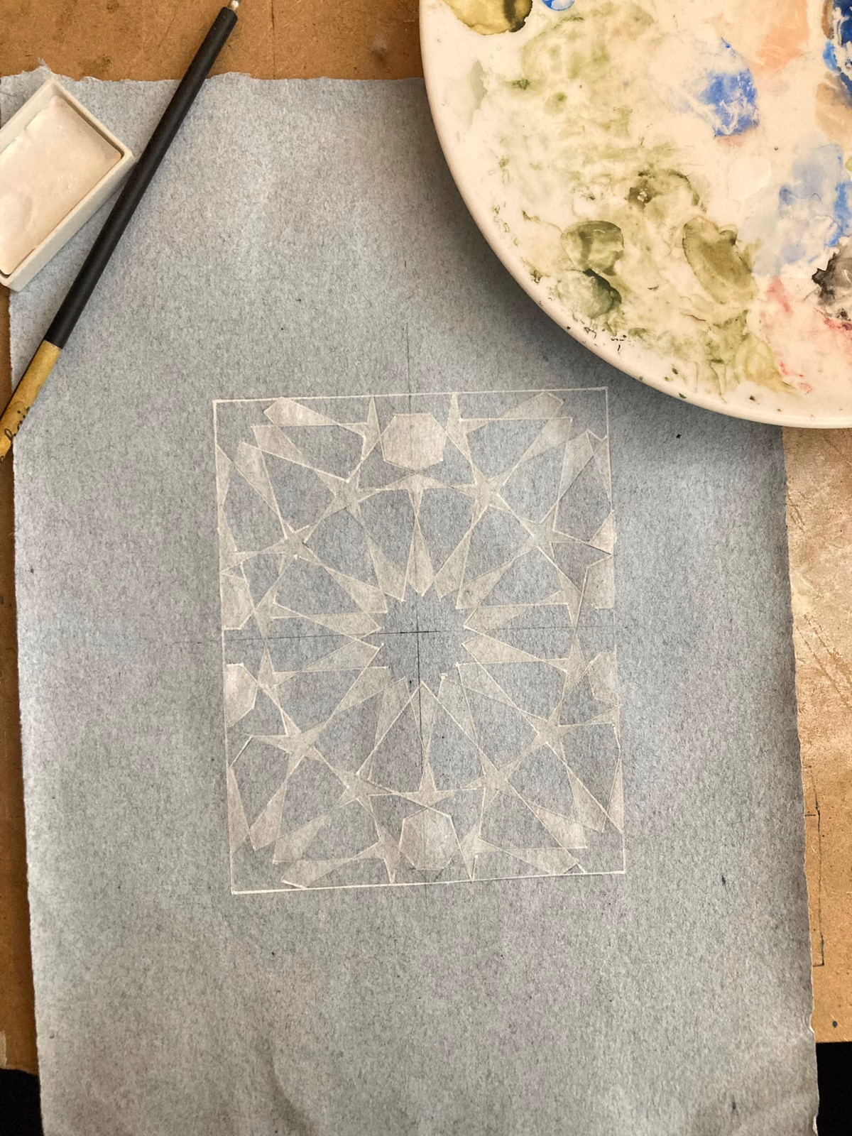 Grey surface with a geometric pattern drawing in progress
