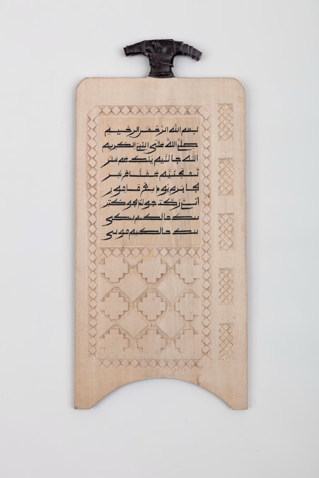 Pale wooden board with calligraphy and delicate pattern work