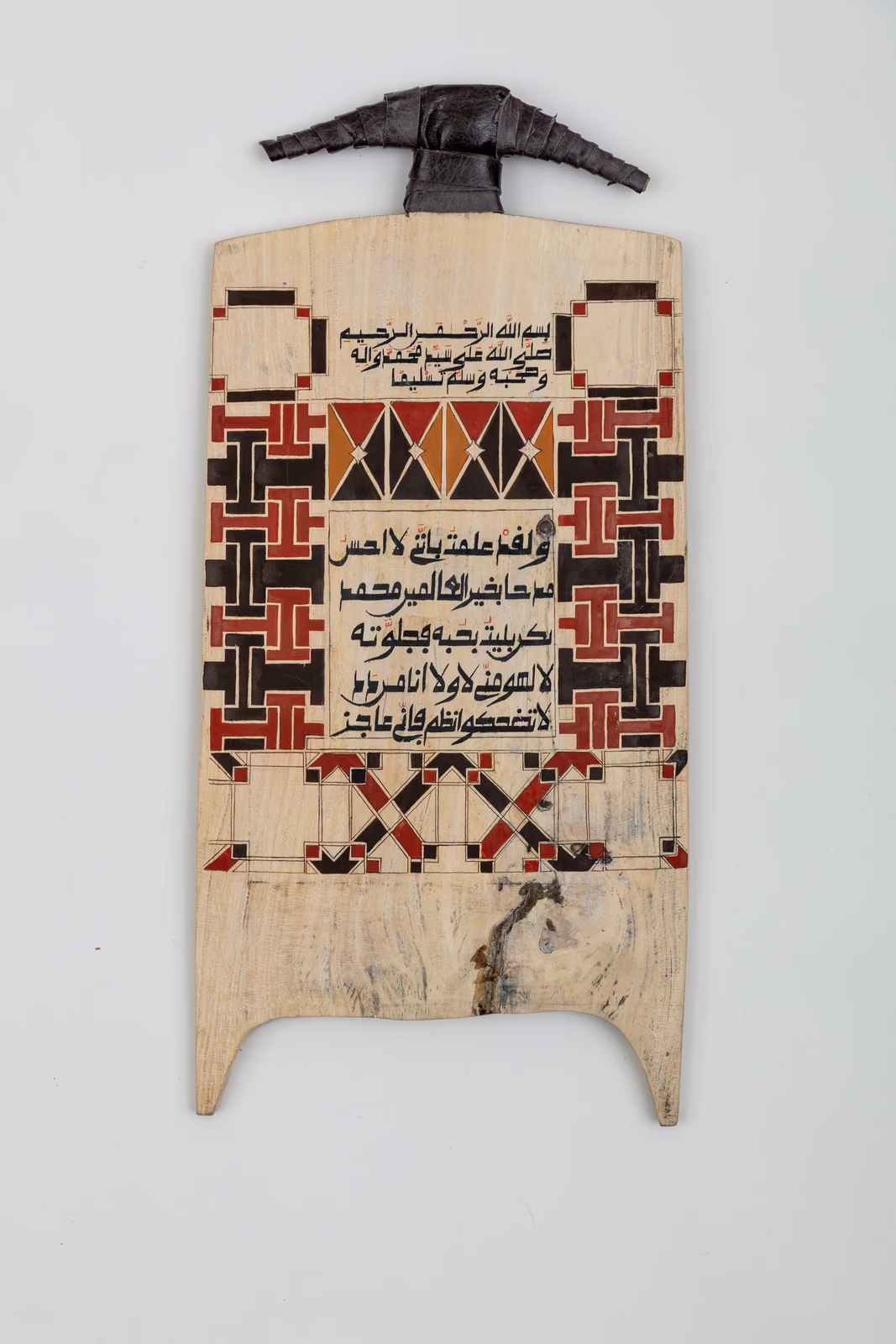 Wooden board with Surah Fatiha calligraphy and red pattern border